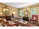 Elegant living room featuring hardwood floors, a decorative fireplace, and abundant natural light at 2004 Riverview Dr, Clayton, NC 27527