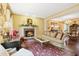 Elegant living room featuring a brick fireplace, plush seating, and hardwood floors at 2004 Riverview Dr, Clayton, NC 27527