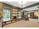 Cozy living room featuring a decorative chandelier, floor to ceiling built-in shelving and a window seat at 2004 Riverview Dr, Clayton, NC 27527