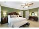 Spacious main bedroom featuring a king bed, classic wooden furniture, and a cozy sitting area with natural light at 2004 Riverview Dr, Clayton, NC 27527