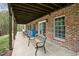 Covered patio with brick siding and outdoor seating offering a relaxing and shaded space at 2004 Riverview Dr, Clayton, NC 27527