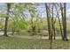Serene river view through mature trees, creating a peaceful and picturesque setting at 2004 Riverview Dr, Clayton, NC 27527