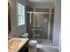 Bathroom featuring shower with tile surround, gray walls and vanity with solid surface counter at 207 Sallinger St, Knightdale, NC 27545