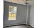 This bedroom features neutral paint, carpet and a window providing natural light at 207 Sallinger St, Knightdale, NC 27545
