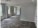 Bright living room with many windows, decorative trim, and attractive wood-look flooring at 207 Sallinger St, Knightdale, NC 27545