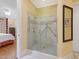 Spacious bathroom with a glass enclosed shower stall, tiled surround, and rainfall shower head at 21 Kimberly Dr, Durham, NC 27707