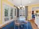 Bright breakfast nook with glass top table, custom rug, and French doors leading to the patio at 21 Kimberly Dr, Durham, NC 27707