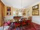 Dining room featuring a chandelier, hardwood floors, and decorative paintings at 21 Kimberly Dr, Durham, NC 27707