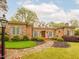 Charming brick home with manicured landscaping and a stone walkway leading to the entrance at 21 Kimberly Dr, Durham, NC 27707