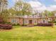 Beautiful brick home with a manicured lawn, mature trees, and attractive landscaping at 21 Kimberly Dr, Durham, NC 27707