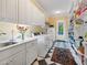 Well-organized laundry room with sleek white cabinetry, granite countertops, and modern appliances at 21 Kimberly Dr, Durham, NC 27707