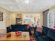 Open-concept living room with a coffered ceiling, view to the kitchen, and elegant furnishings at 21 Kimberly Dr, Durham, NC 27707