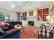 Spacious living room with a fireplace, built-in shelving, and comfortable seating arrangement at 21 Kimberly Dr, Durham, NC 27707