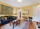 Comfortable living room with a plush sofa, decorative rug, and a writing desk at 21 Kimberly Dr, Durham, NC 27707