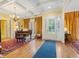 Elegant living room featuring hardwood floors, a coffered ceiling, and a grand piano at 21 Kimberly Dr, Durham, NC 27707
