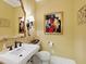 Stylish powder room with a pedestal sink, elegant mirror, and sophisticated decor at 21 Kimberly Dr, Durham, NC 27707
