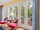 Cozy sunroom with views to the backyard, stylish chairs, and abundant natural light at 21 Kimberly Dr, Durham, NC 27707