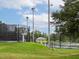 Community tennis courts featuring fenced perimeters, outdoor lighting, and shelters for relaxation at 21 Kimberly Dr, Durham, NC 27707