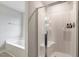 Bright bathroom featuring a bathtub and enclosed shower at 211 Tobacco Barn Dr, Angier, NC 27501