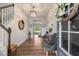Bright entryway with hardwood floors, stylish decor, and a staircase leading to the upper level at 211 Tobacco Barn Dr, Angier, NC 27501
