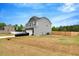 Side view of a gray two-story home with a spacious yard and a two-car garage at 211 Tobacco Barn Dr, Angier, NC 27501