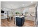 Open-concept layout combines the kitchen, dining area, and living room creating a harmonious living space at 211 Tobacco Barn Dr, Angier, NC 27501