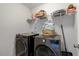 A laundry room equipped with a large capacity washer, dryer, and storage shelf at 211 Tobacco Barn Dr, Angier, NC 27501