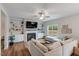 Cozy living room with built-in shelves, a fireplace, and a large sectional sofa for comfortable seating at 211 Tobacco Barn Dr, Angier, NC 27501