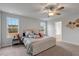 Primary bedroom featuring a ceiling fan, windows and carpeted floors and side table at 211 Tobacco Barn Dr, Angier, NC 27501