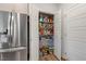 Walk-in pantry with wire shelving and stainless steel refrigerator for ample storage space at 211 Tobacco Barn Dr, Angier, NC 27501