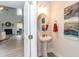 Bright powder room featuring a pedestal sink, modern lighting, and decorative artwork at 215 Kipling Creek Dr, Fuquay Varina, NC 27526