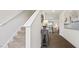 Bright hallway featuring hardwood floors with a staircase leading upstairs at 2152 Monk Dr, Haw River, NC 27258