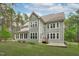Exterior of the home featuring a backyard, deck, and mature trees at 2408 Merion Creek Dr, Apex, NC 27539