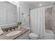 Bathroom with granite countertop vanity, tub, shower and tile surround at 2408 Merion Creek Dr, Apex, NC 27539