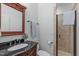 Bathroom featuring a vanity with black granite and a tiled walk-in shower at 2408 Merion Creek Dr, Apex, NC 27539