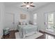 Cozy bedroom with ample natural light, a comfortable bed, and a private outdoor access at 2408 Merion Creek Dr, Apex, NC 27539
