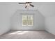 Bright bedroom with a large window, modern ceiling fan, and neutral carpet flooring at 2408 Merion Creek Dr, Apex, NC 27539