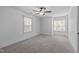 Spacious bedroom with neutral carpet, two windows and modern ceiling fan at 2408 Merion Creek Dr, Apex, NC 27539