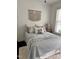 Well-lit bedroom with modern decor, comfortable bedding, and dark-stained hardwood floors at 2408 Merion Creek Dr, Apex, NC 27539