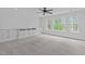 Expansive carpeted bedroom with built-in storage and large windows offering natural light at 2408 Merion Creek Dr, Apex, NC 27539
