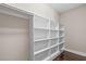 Walk-in closet offers ample storage with built-in shelving and wood floors at 2408 Merion Creek Dr, Apex, NC 27539