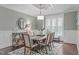 Elegant dining room with wainscoting, decorative chandelier, and a window at 2408 Merion Creek Dr, Apex, NC 27539
