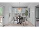 Bright dining room with natural light, a round table, and views of the surrounding nature at 2408 Merion Creek Dr, Apex, NC 27539