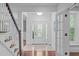 Bright foyer with tile flooring, a staircase and a door with sidelight windows at 2408 Merion Creek Dr, Apex, NC 27539