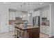 Spacious kitchen with a large island, granite countertops, and stainless steel appliances at 2408 Merion Creek Dr, Apex, NC 27539