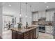 Spacious kitchen featuring a large island with granite countertops and stainless steel appliances at 2408 Merion Creek Dr, Apex, NC 27539