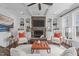 Bright and open living room with a stone fireplace and comfortable seating at 2408 Merion Creek Dr, Apex, NC 27539