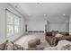 Spacious living room with a large window, built-in shelving, and cozy furnishings at 2408 Merion Creek Dr, Apex, NC 27539
