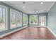 Bright living room with many windows, wood flooring, and recessed lighting at 2408 Merion Creek Dr, Apex, NC 27539