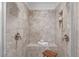 Tiled shower stall with bench and built-in shelves provides a spa-like retreat at 2408 Merion Creek Dr, Apex, NC 27539